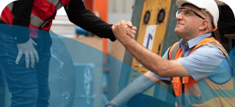 Man at a construction site being helped to stand