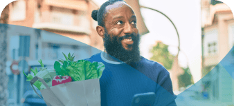 Man walking with a bag of groceries