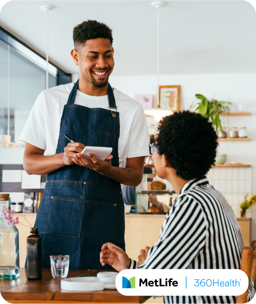 Waiter taking an order in a cafe