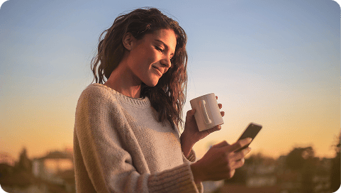 Woman at sunset on her phone.