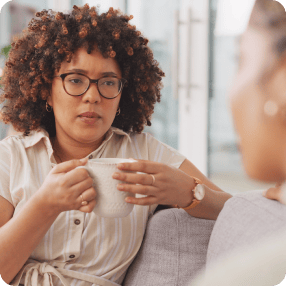 Older woman and her adult daughter laughing together